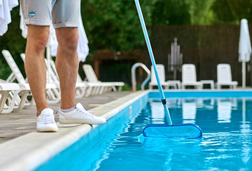 Technician cleaning a commercial pool during professional service by Commercial Pool Kings.