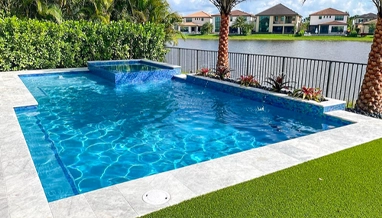 Luxury residential pool with lake view, professionally maintained by Commercial Pool Kings for clean, safe water.