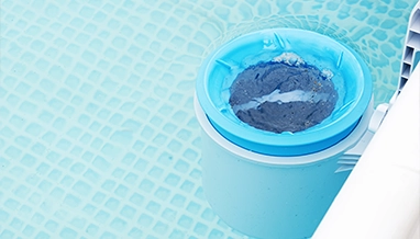 Leaf skimmer removing debris during professional pool cleaning by Commercial Pool Kings.