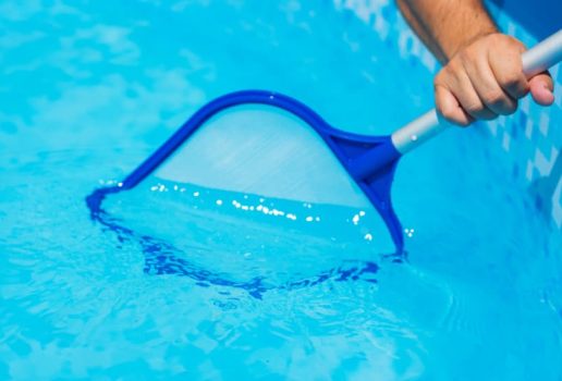 Pool skimmer net removing debris during professional pool cleaning by Commercial Pool Kings.